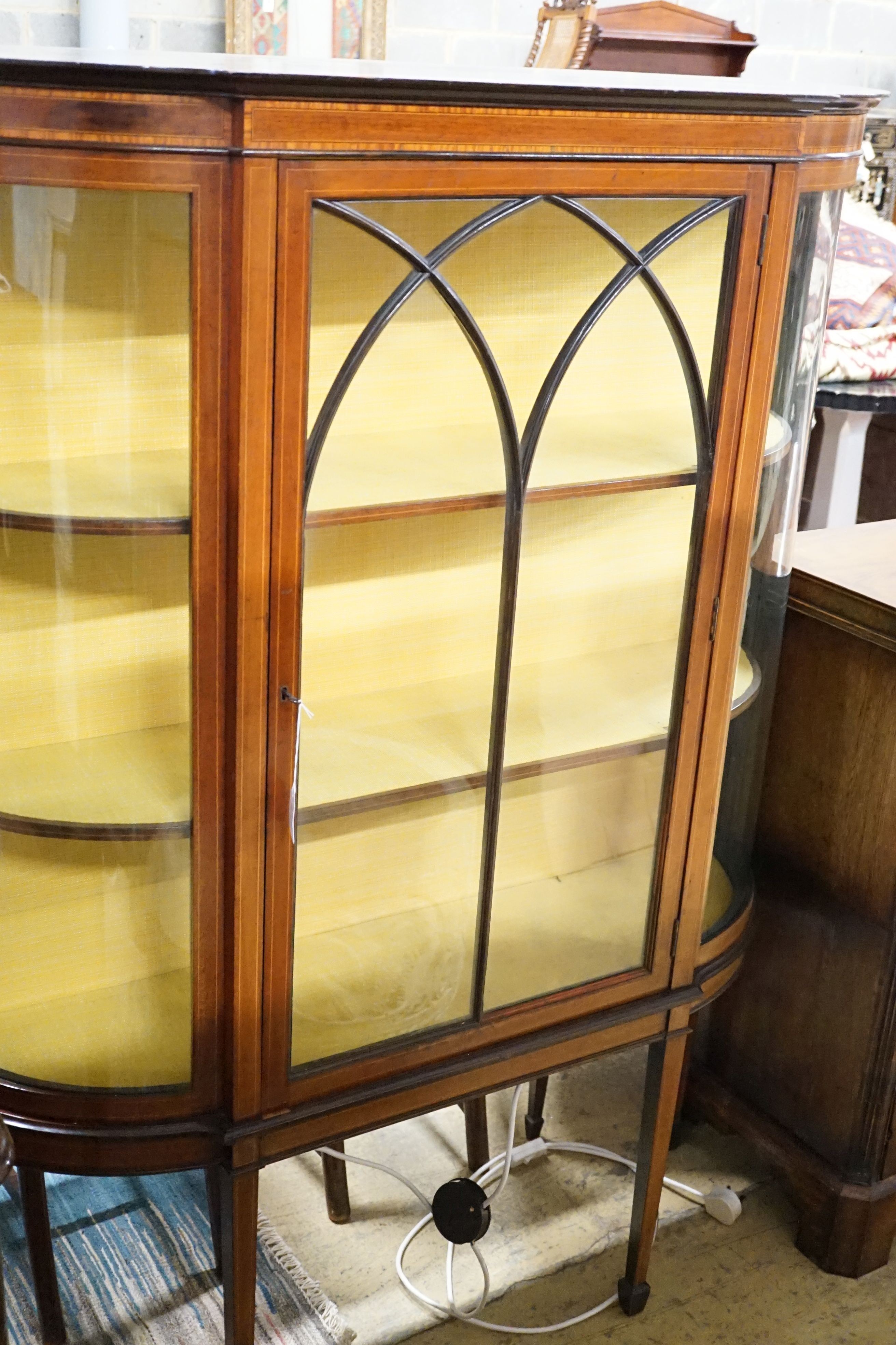 An Edwardian inlaid mahogany bow break front display cabinet, 122 cm wide, 35.5 cm deep, 159 cm high